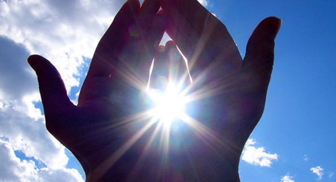 PHOTO-HANDS-HOLDING-SUN-BLUE-SKY.jpg